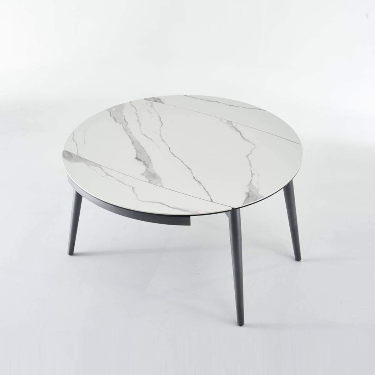 Side view of the round table showing the marble pattern top and black metal legs