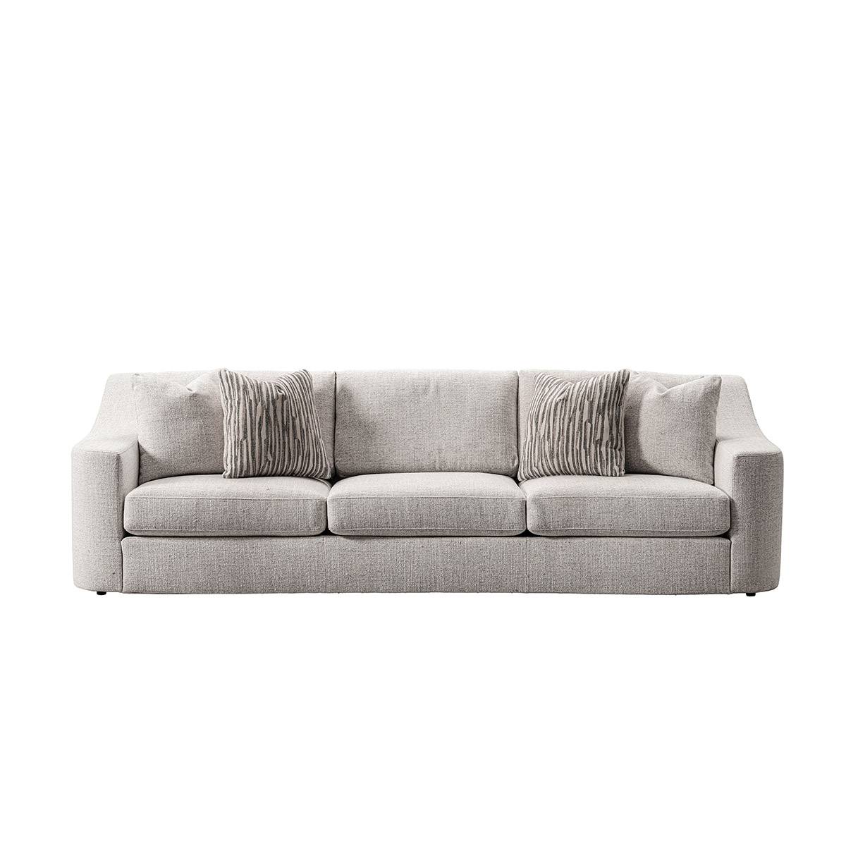 Living room setting featuring the fabric sofa, round ottomans, and side tables