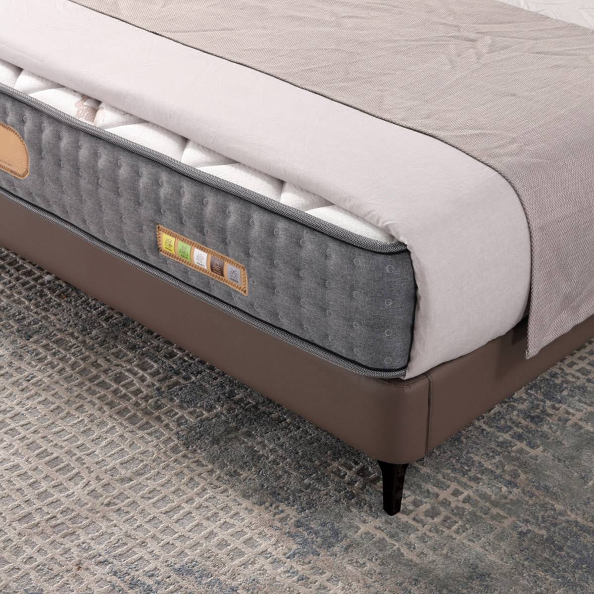 Close-up of the brown leather headboard showing vertical stitching and texture