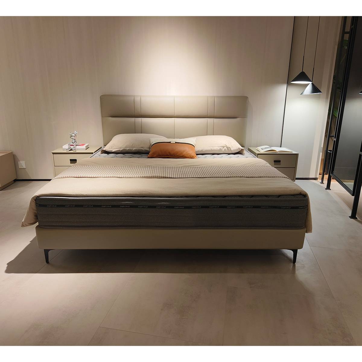 Front view of the beige leather soft bed showing the headboard and slat base