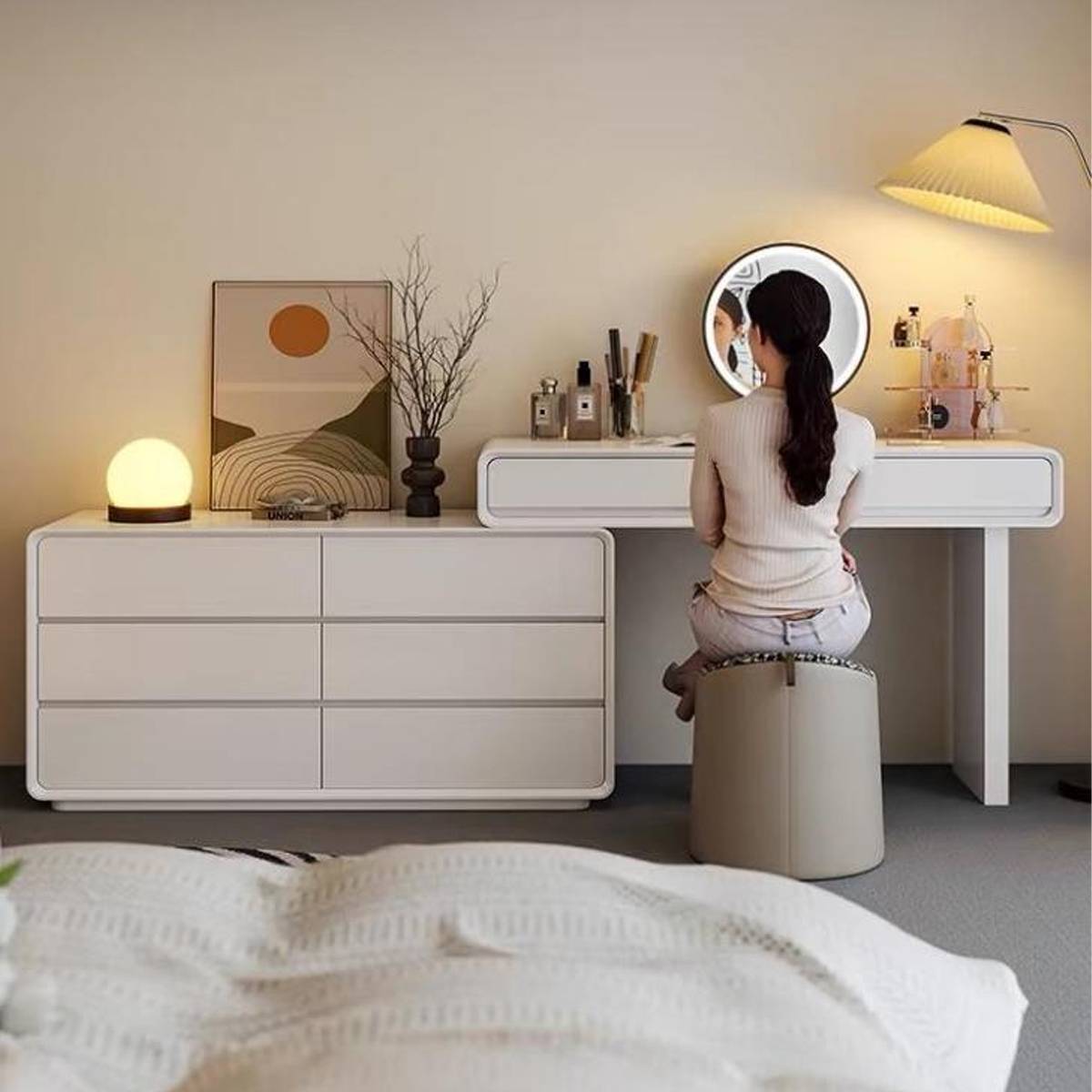 Woman sitting at the vanity set using the mirror