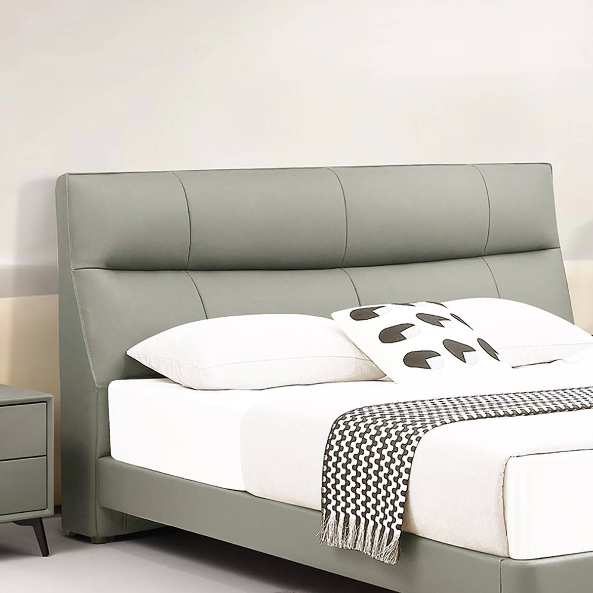 Close-up of the tufted headboard and pillows on the bed