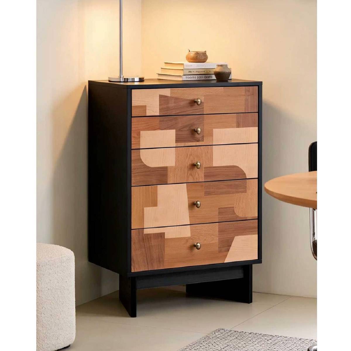 Chest of drawers styled with books and lamp in a home setting