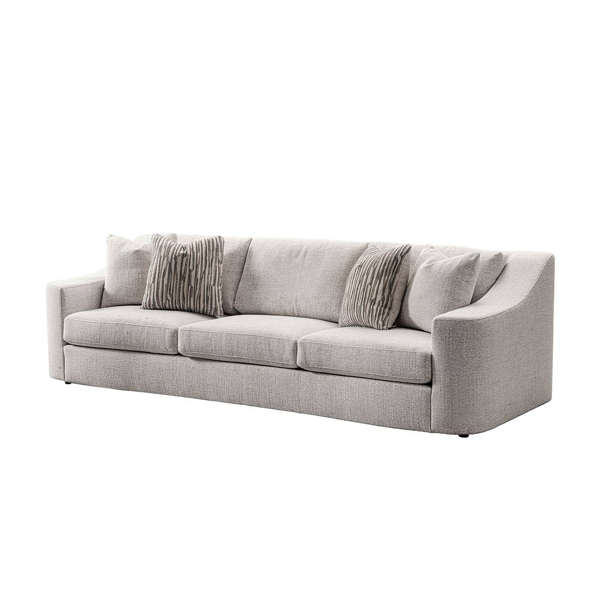 Side view of the light grey fabric sofa with striped pillows