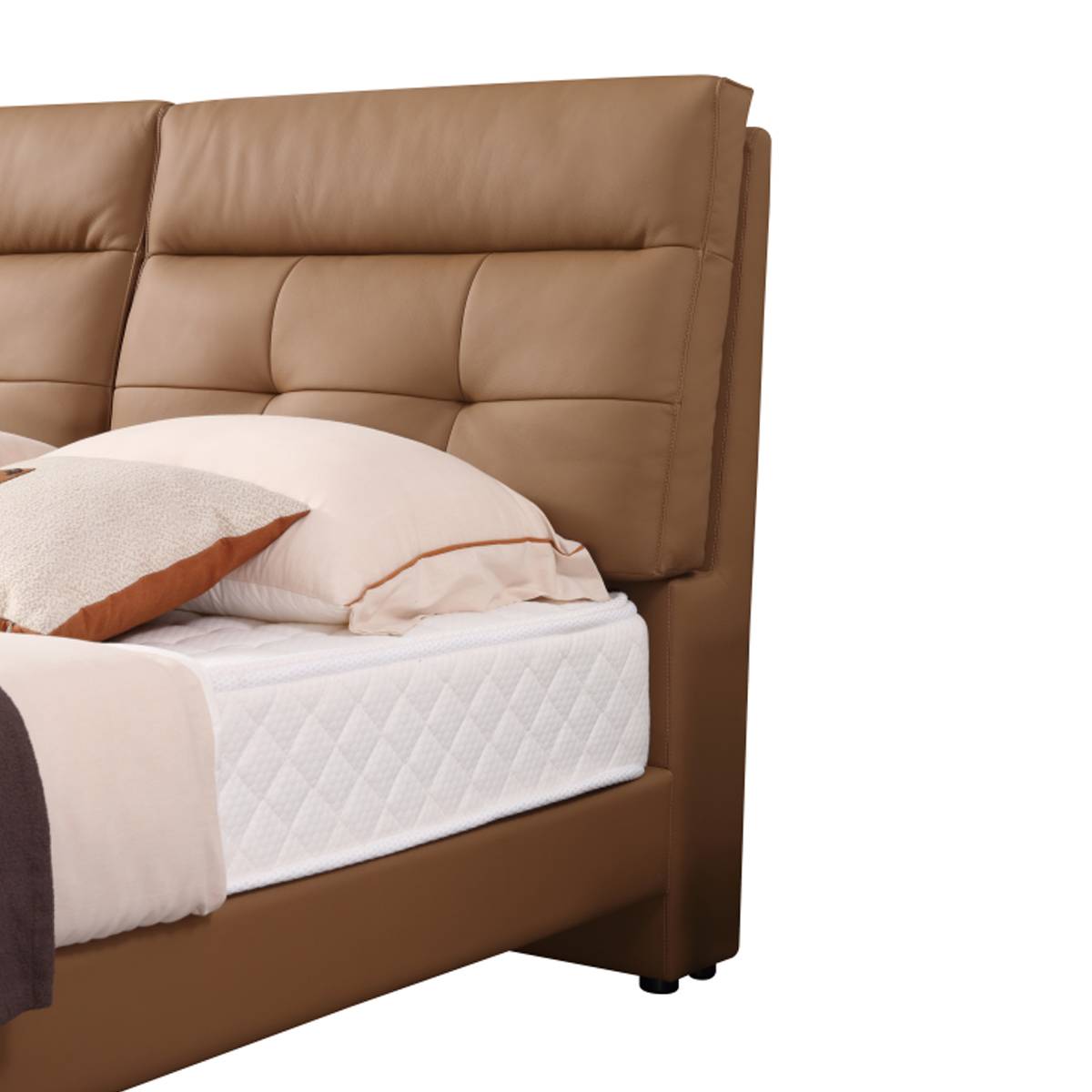 Close-up of the tufted leather headboard and pillows