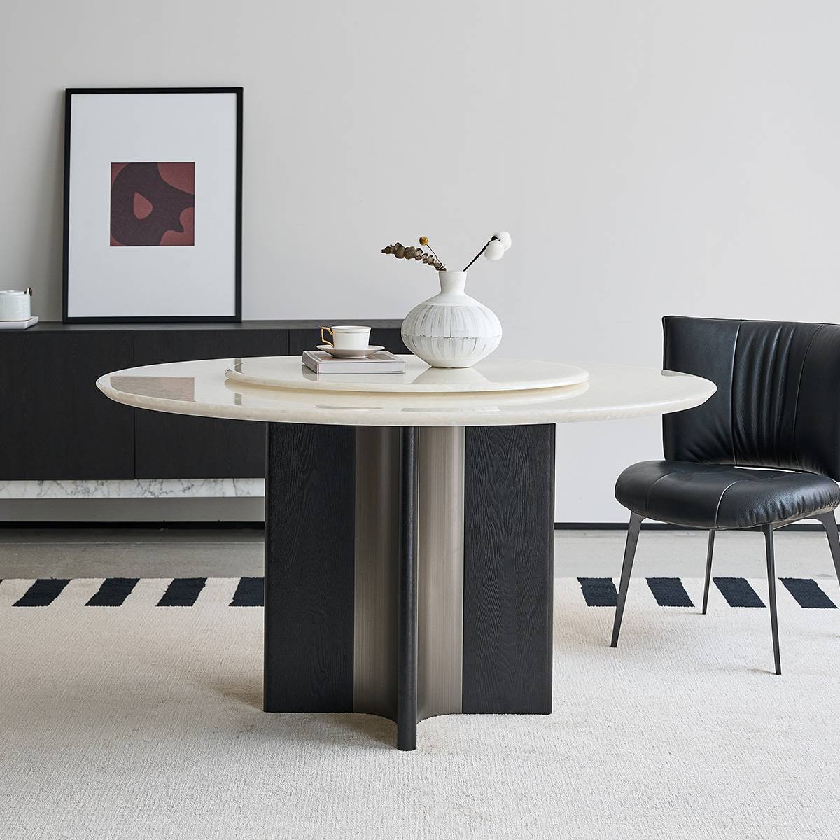 Side profile view of the dining table highlighting the stainless steel base and stone top thickness.