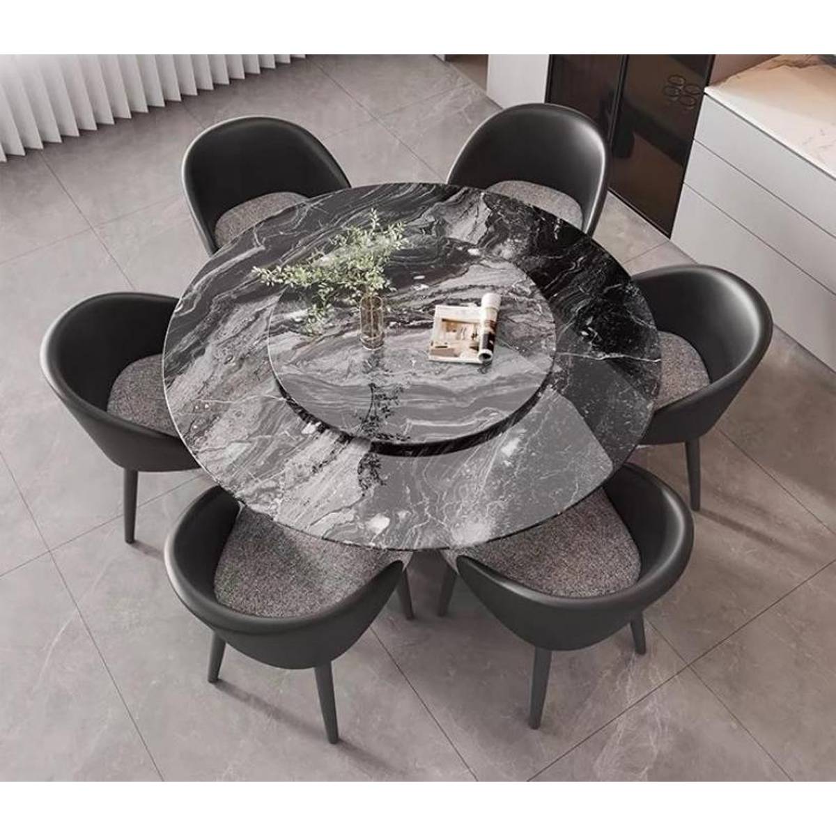 Top-down view of the round marble dining table showing the rotating tray and seating arrangement
