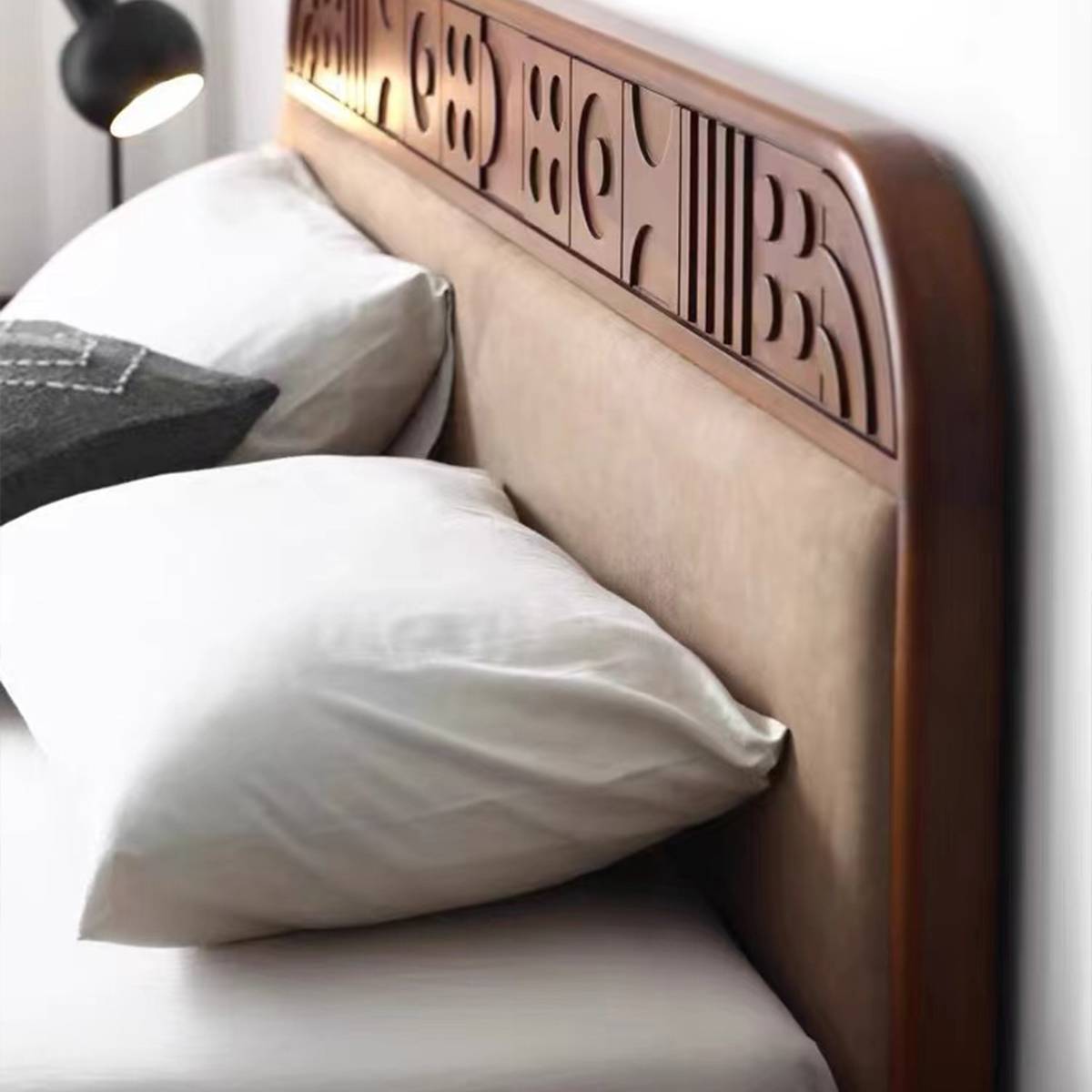 Detail shot of the carved geometric patterns on the wooden headboard
