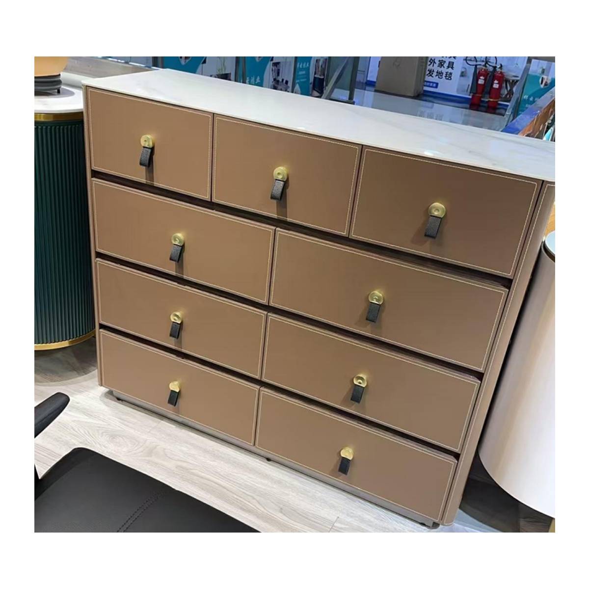 Tan saddle leather sideboard showing drawer details and brass hardware