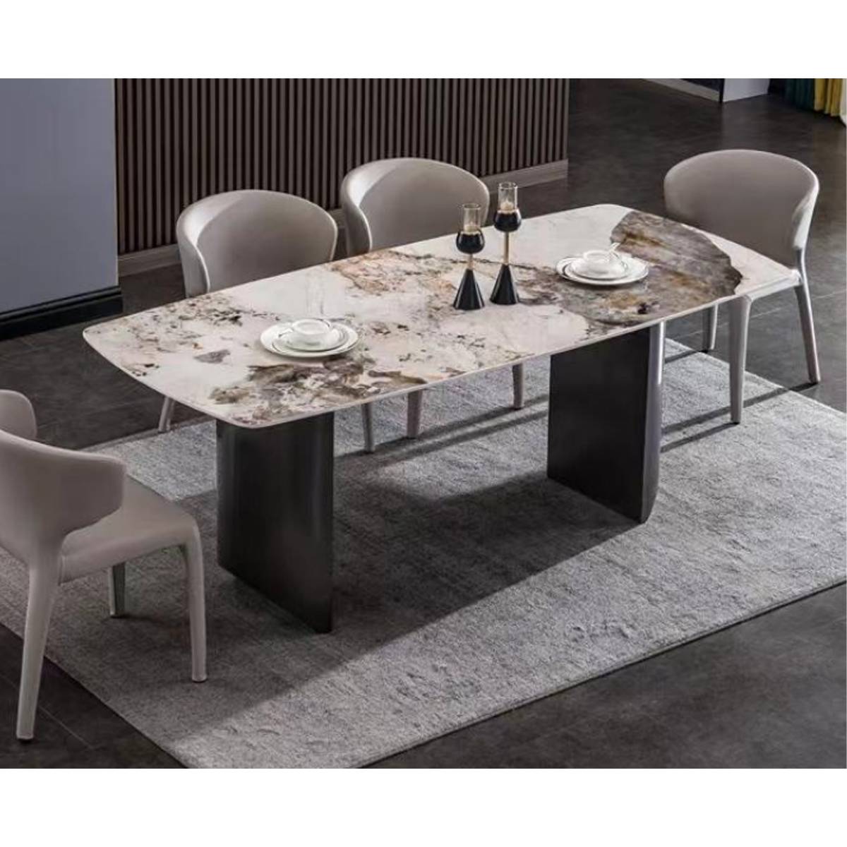 High-angle view of the dining table set with tableware, showing the stone texture and stainless steel base.