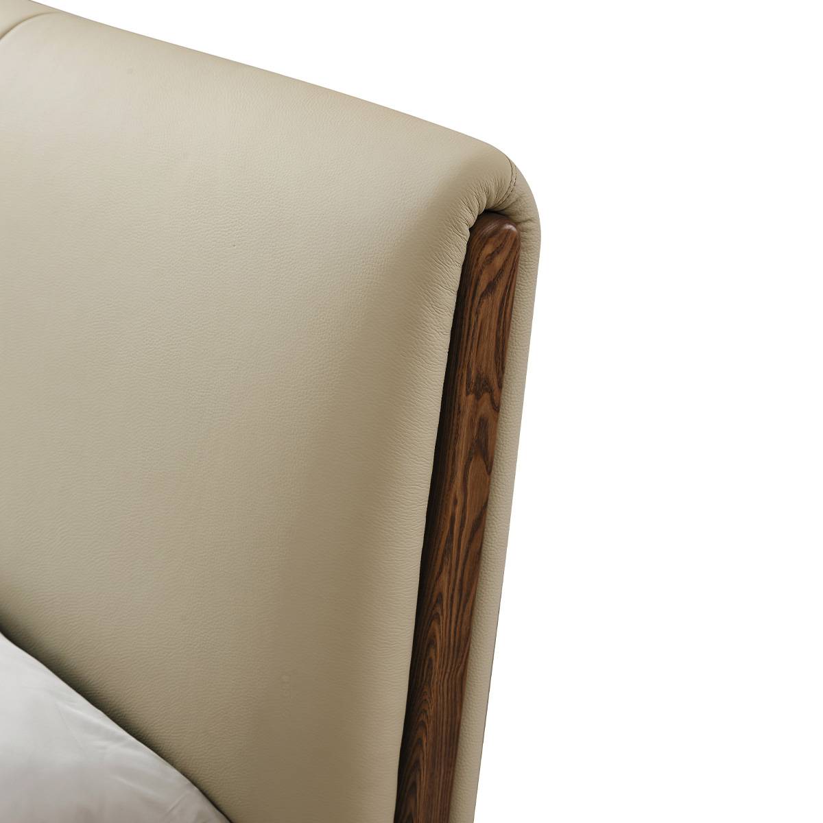 Close-up detail of the headboard showing the top-grain leather texture and solid ash wood side accent