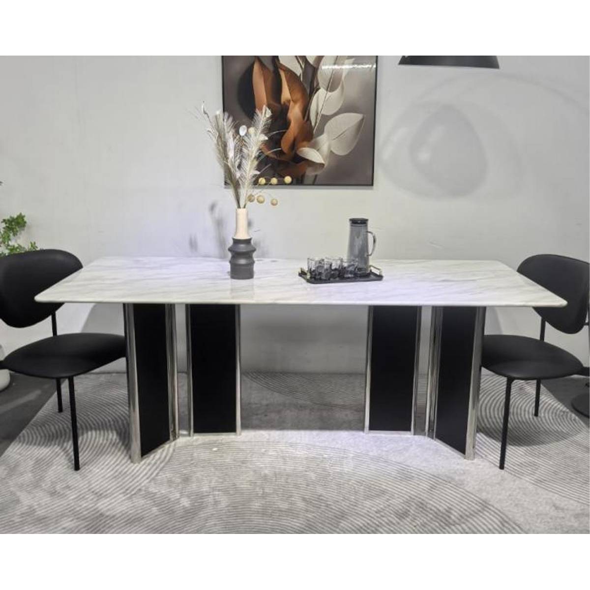 Front view of the marble dining table with black chairs