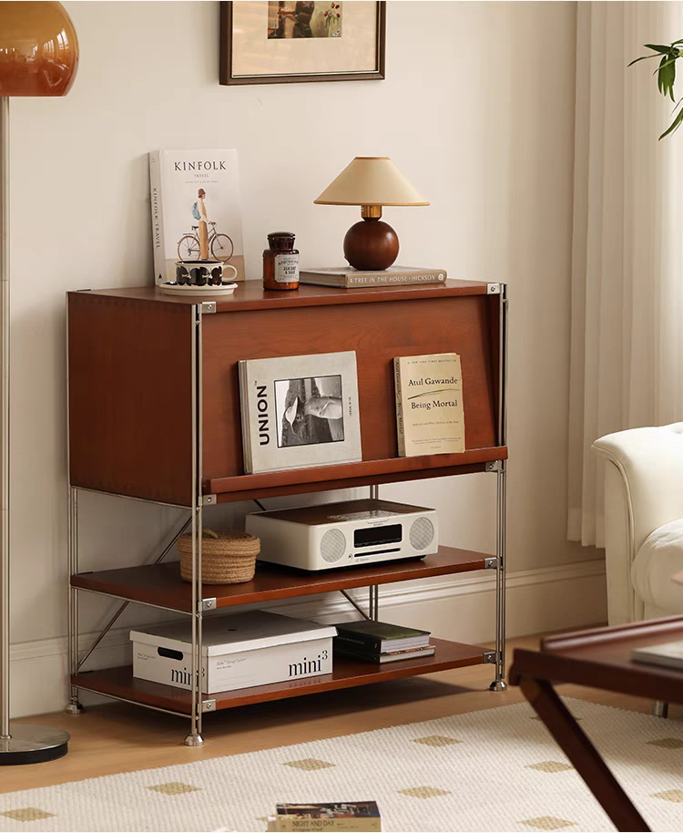 Sideboard styled with magazines, a vase, and a radio in a living room