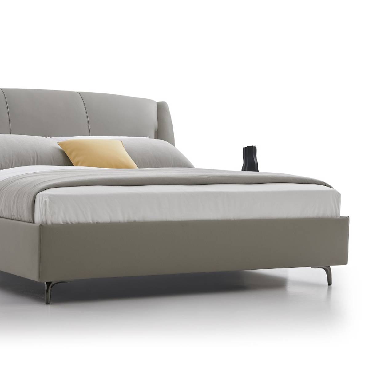 Close-up detail of the bed frame, mattress, and metal legs