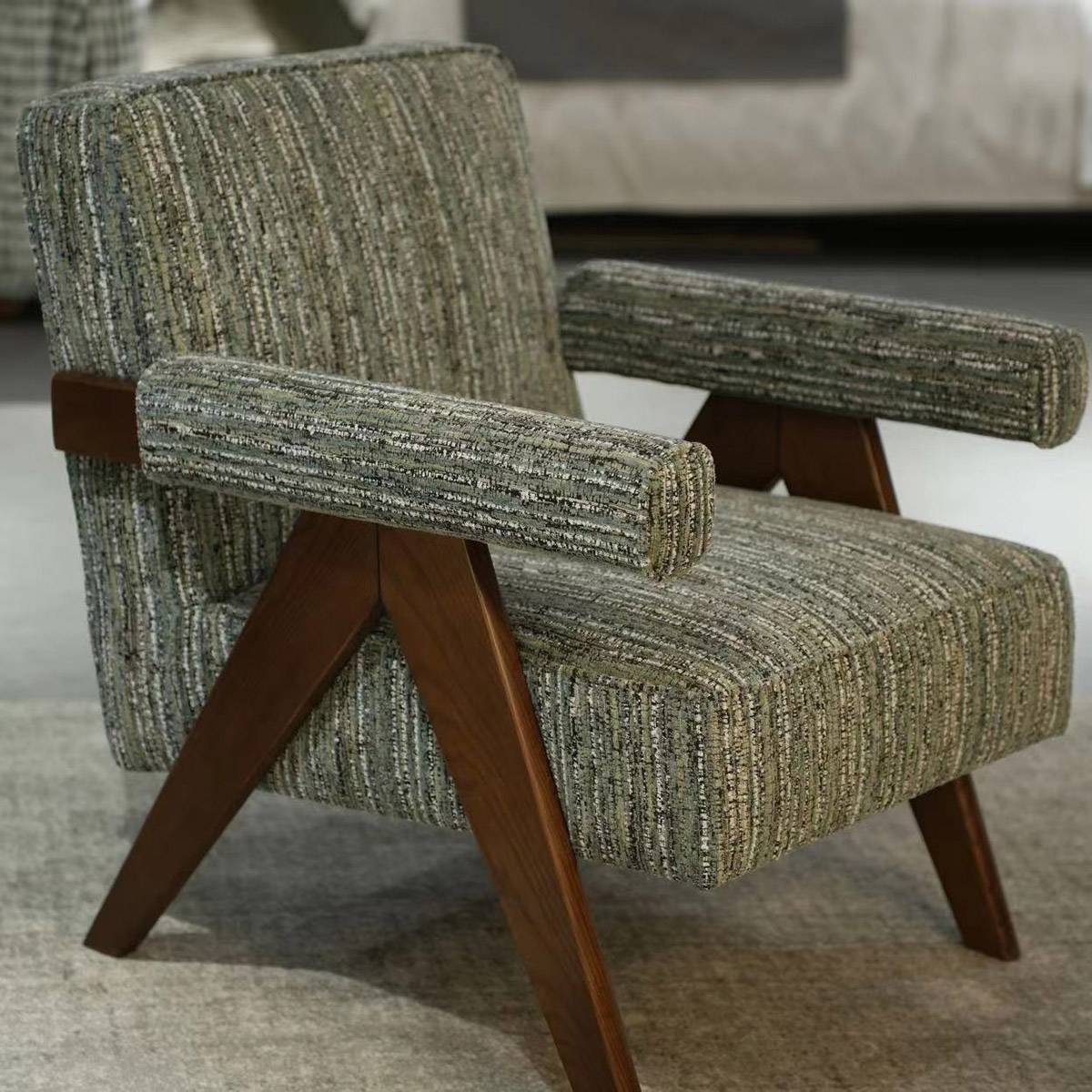 Side view of the Lida Lounge Chair showing the fabric texture and wooden frame