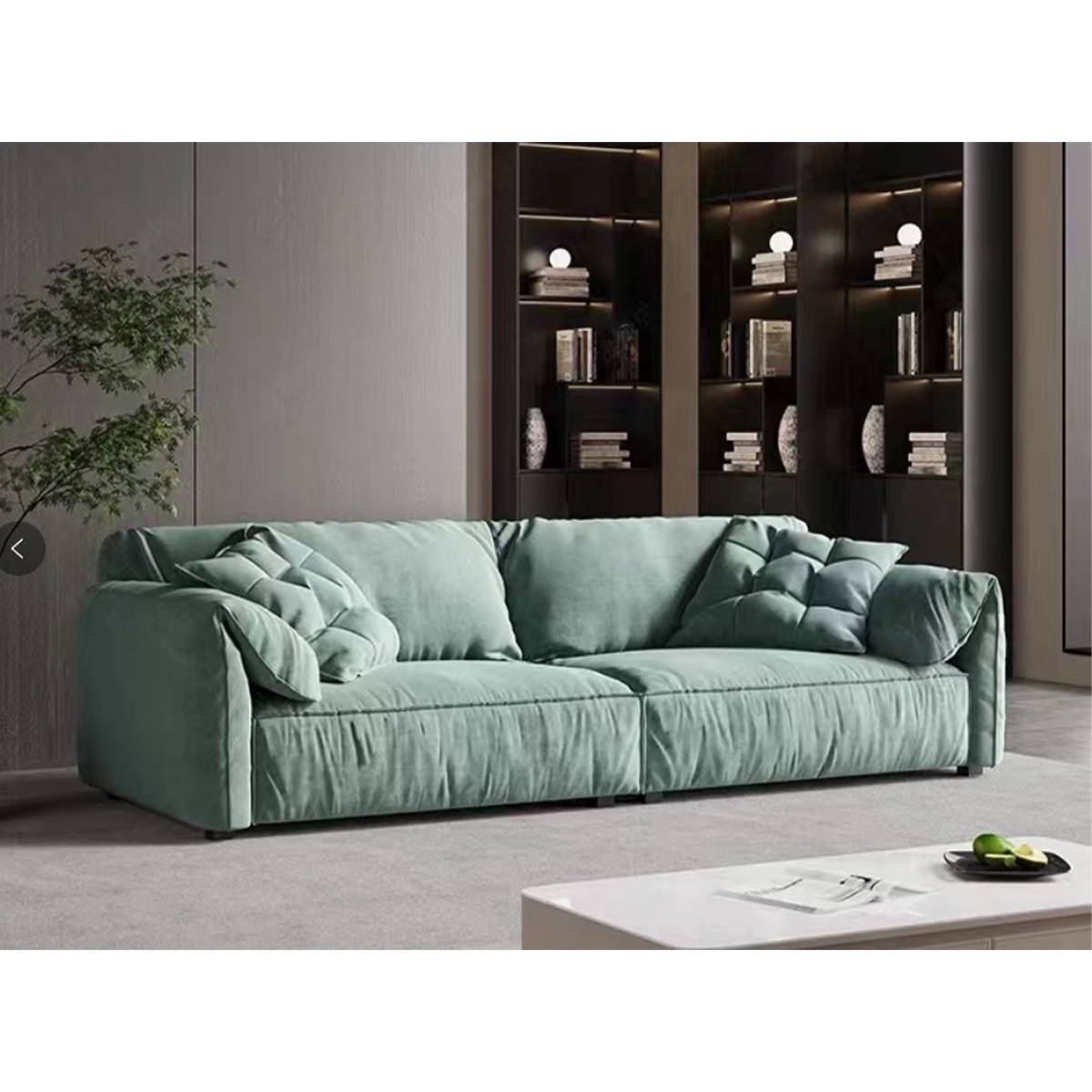 Green Elephant Ear sofa in a living room with bookshelves