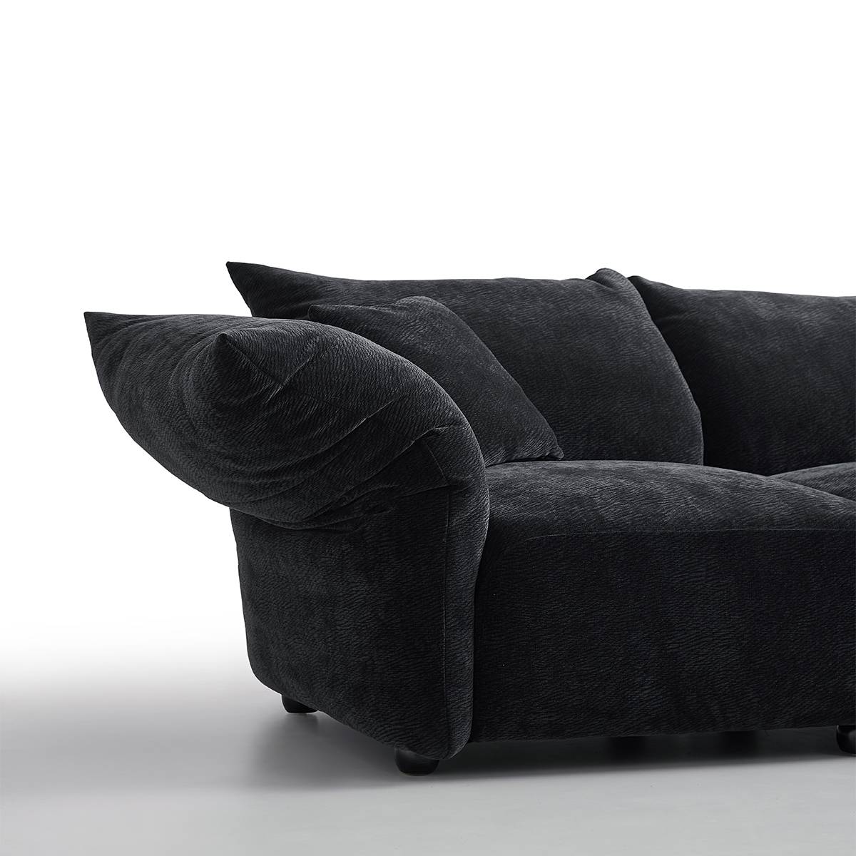 Close-up of the left armrest showing the petal shape and velvet texture.