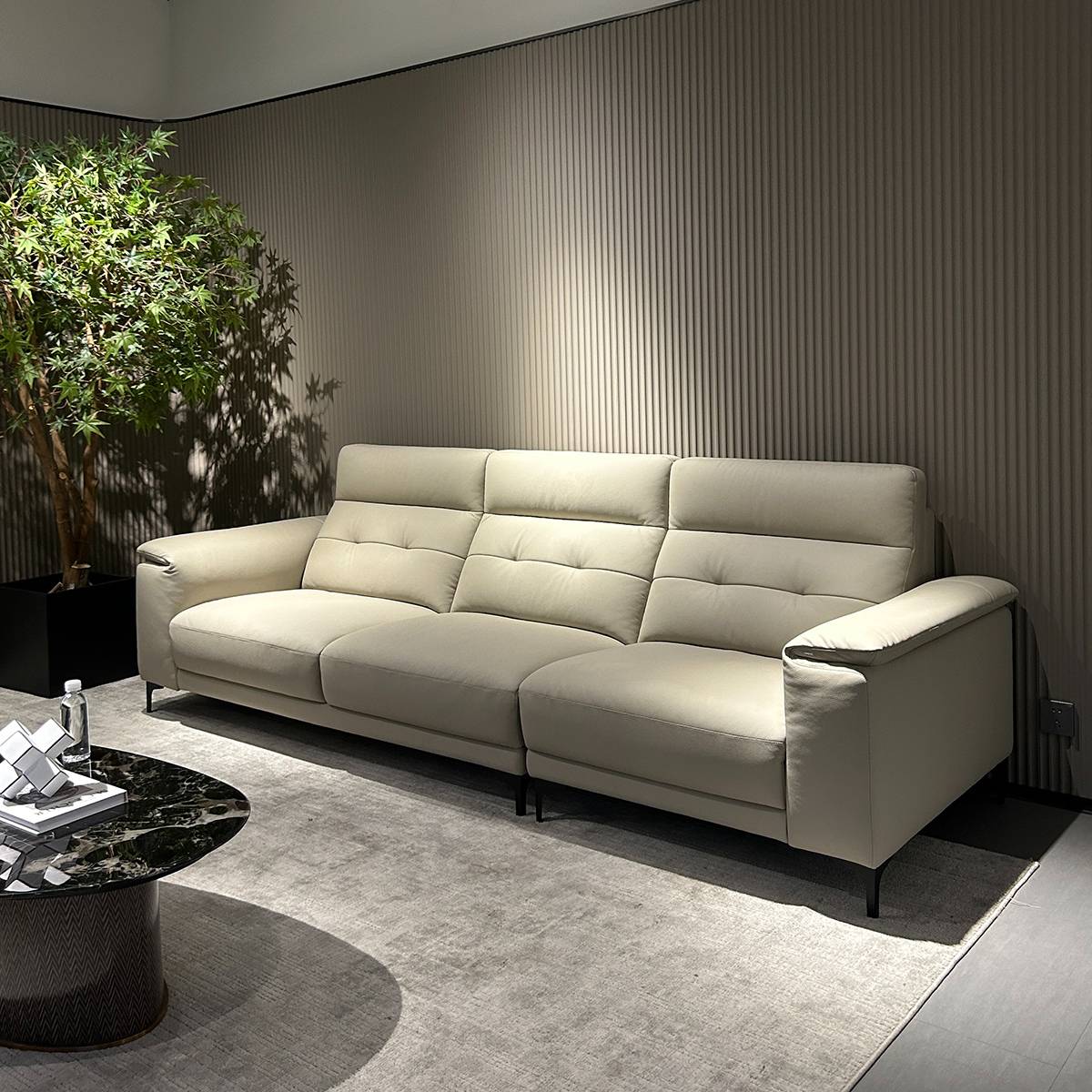Side view of a beige 3-seater leather sofa in a modern living room setting
