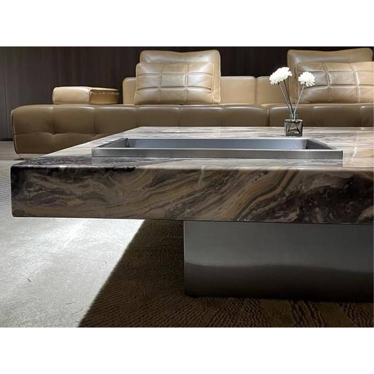 Side profile view of the coffee table showing the thick marble slab and stainless steel base