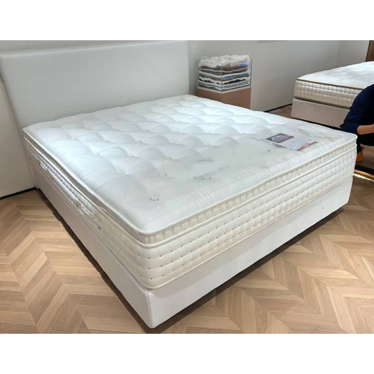 Mattress displayed on a bed base in a showroom setting