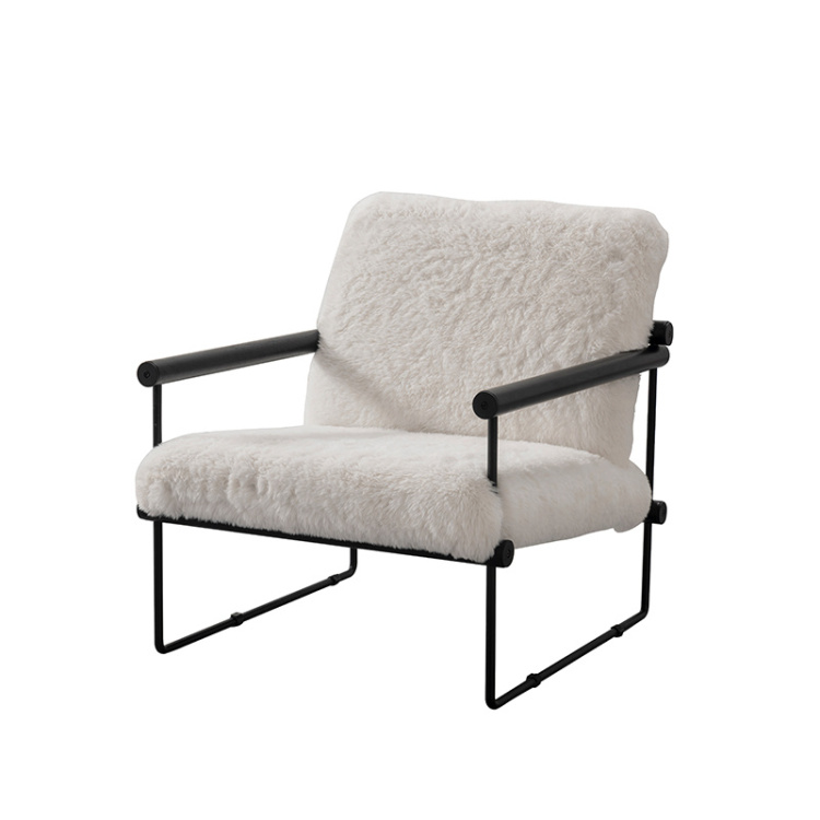 A white furry lounge chair with a black metal frame.
