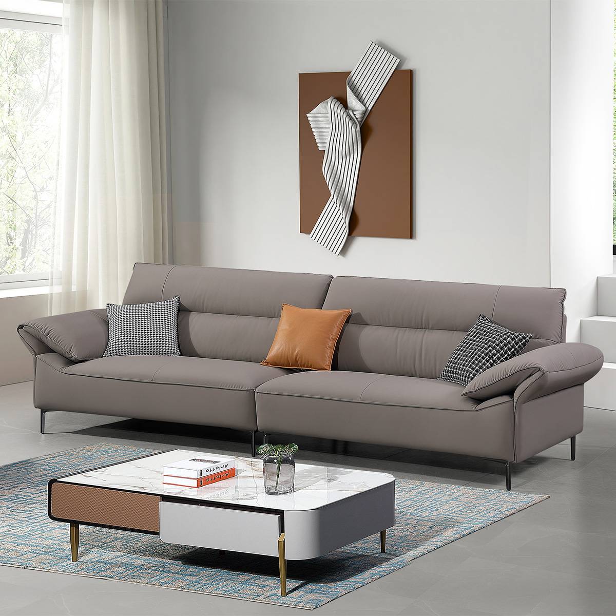 Grey straight sofa in a modern living room with a marble coffee table and wall art