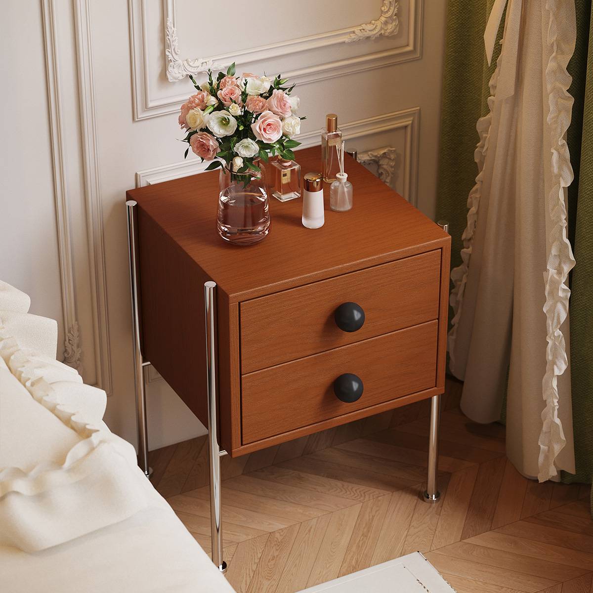 Angled view of the bedside table showing the top surface with perfume bottles and a vase of flowers.