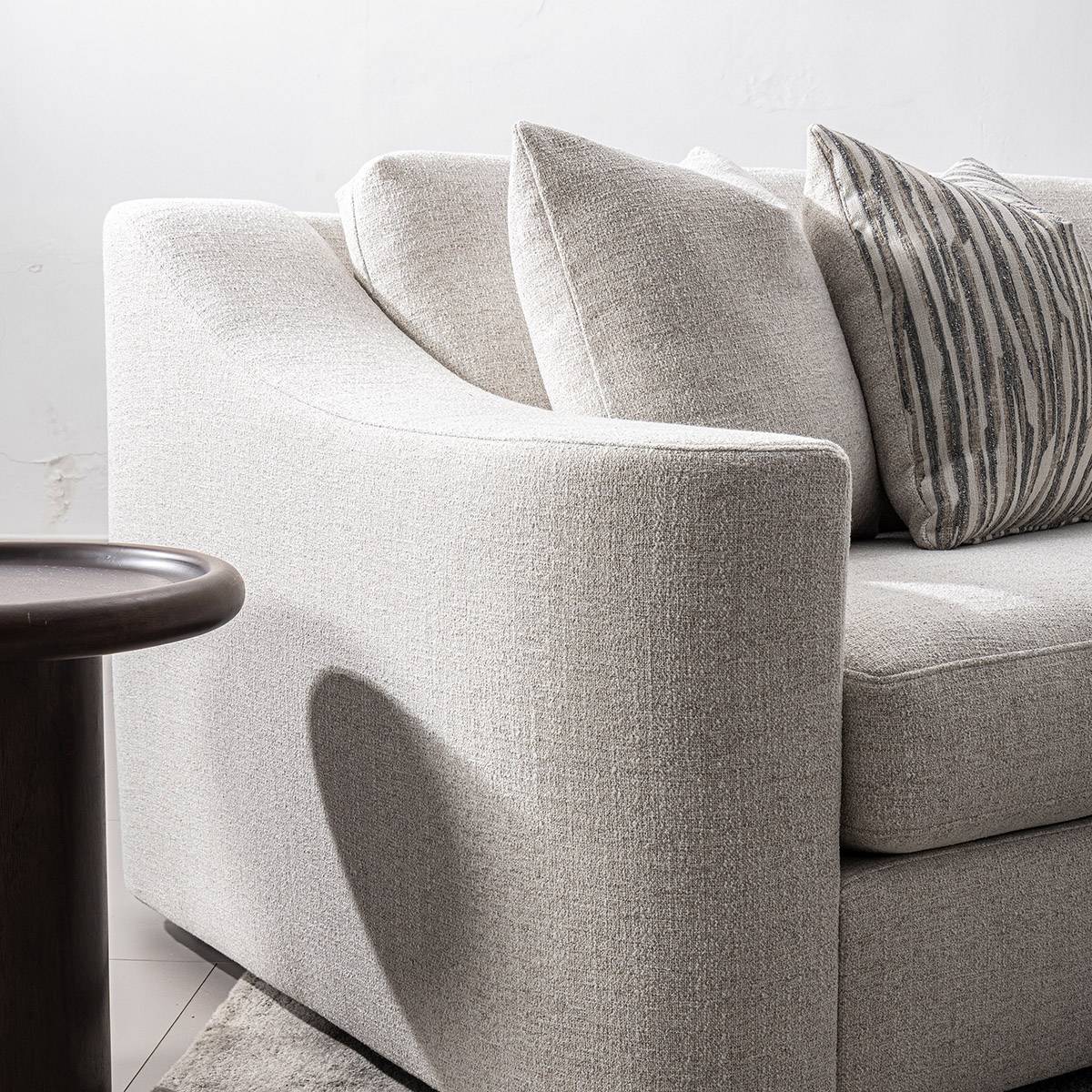 Detail shot of the sofa armrest texture and side table