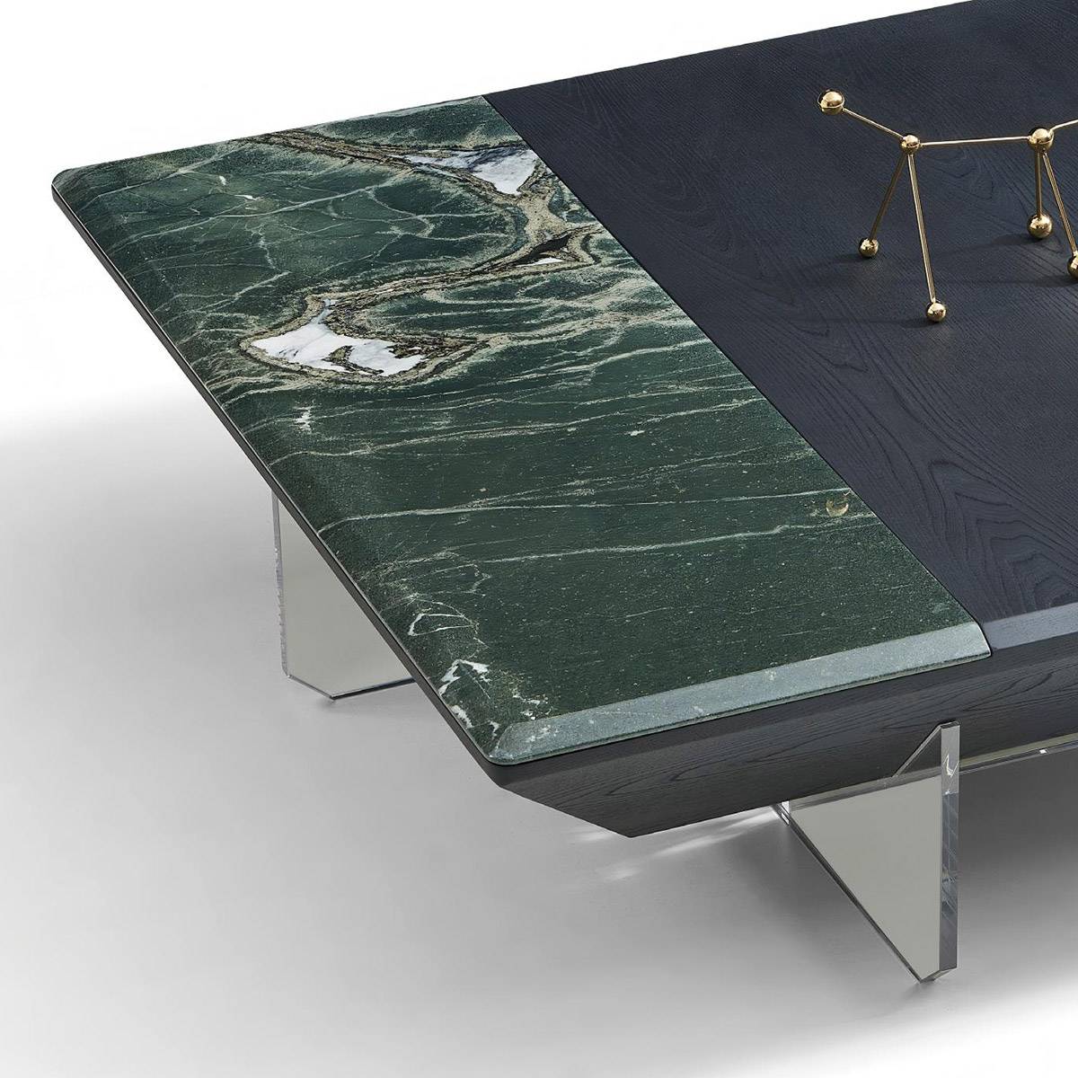 Close-up detail of the green natural stone surface and the edge of the dark wood tabletop.