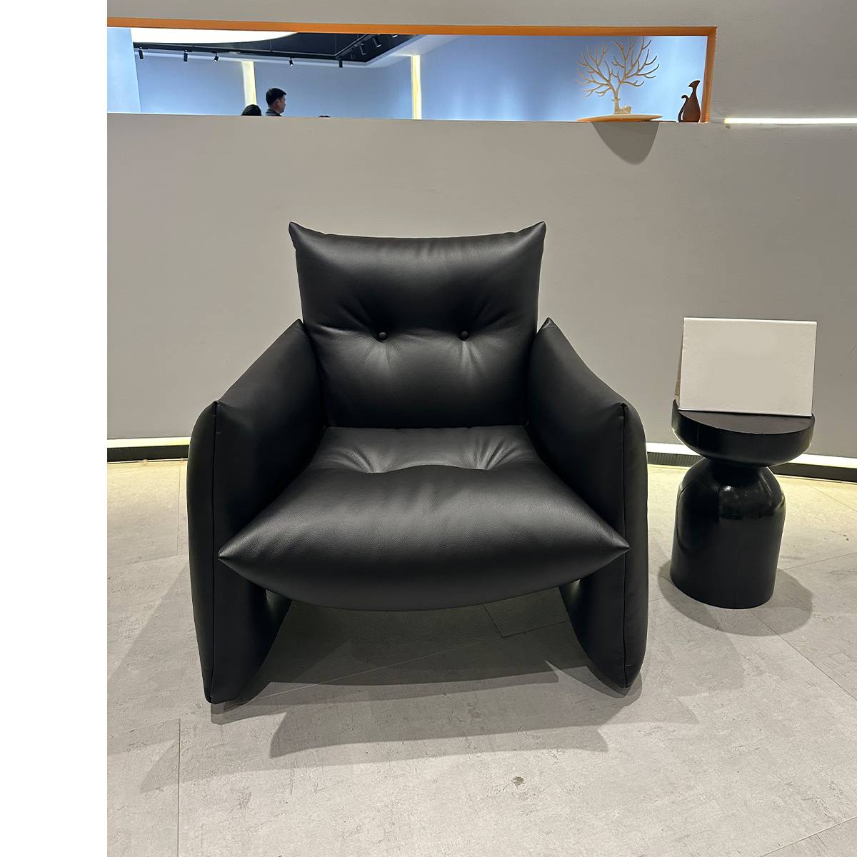 Front view of the black lounge chair showing the seat and armrests