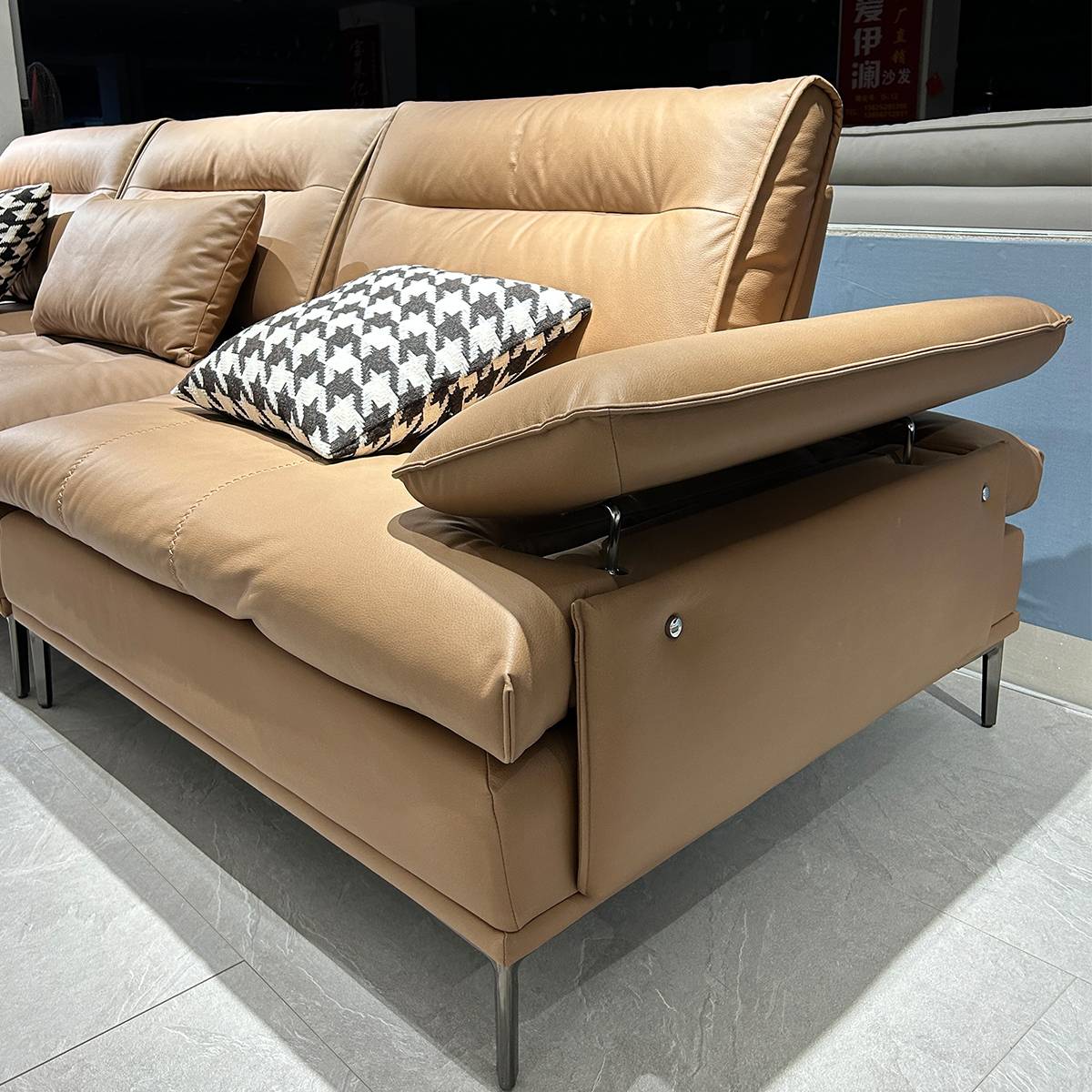 Side view of the sofa showing the armrest and metal legs