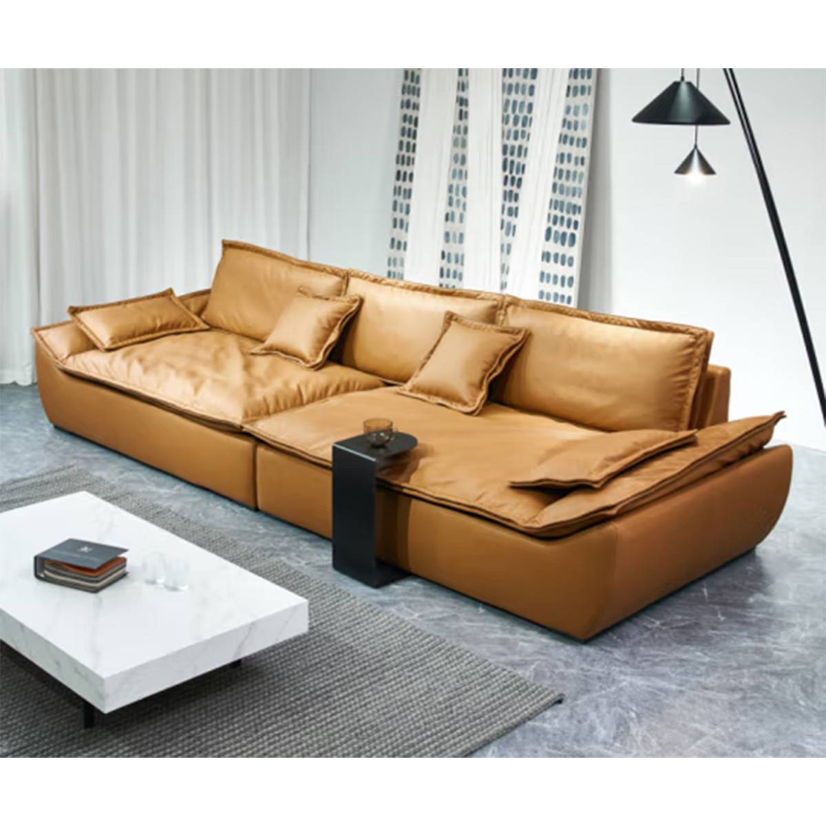 Side angle view of the tan leather straight sofa showing the depth and cushion arrangement.