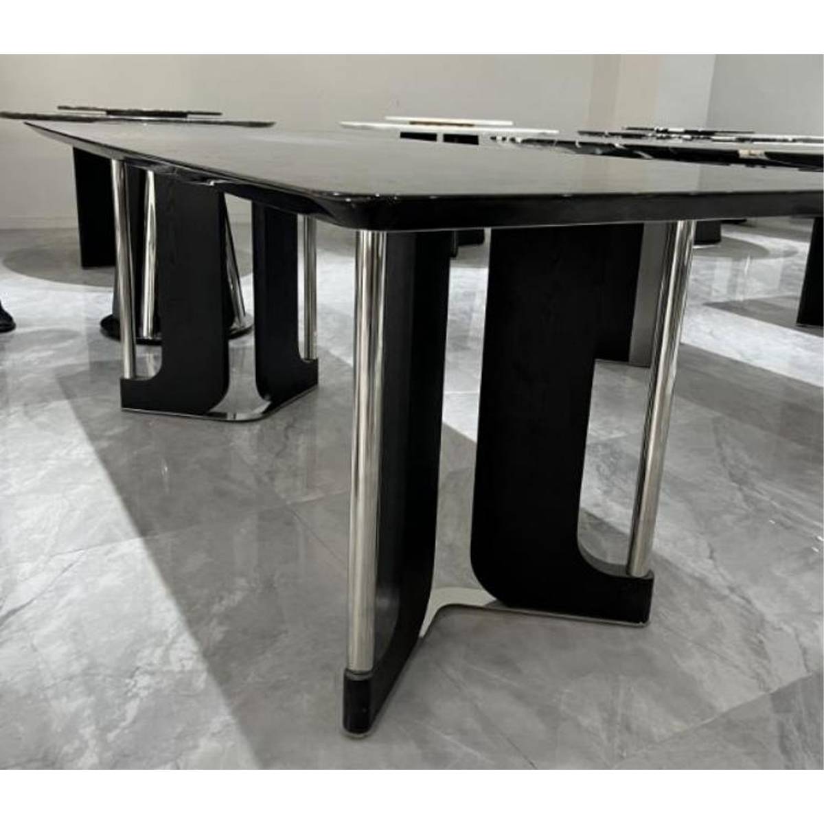 Close-up detail of the dining table base showing the stainless steel and wood construction