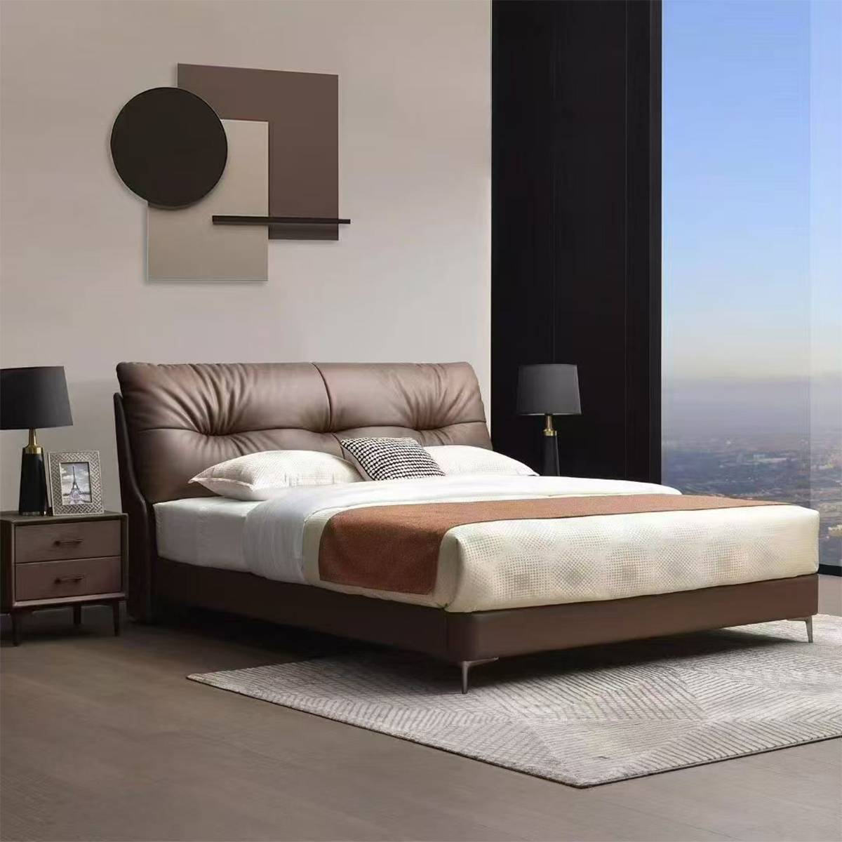 Bedroom setting showing the bed with a window view and bedside table