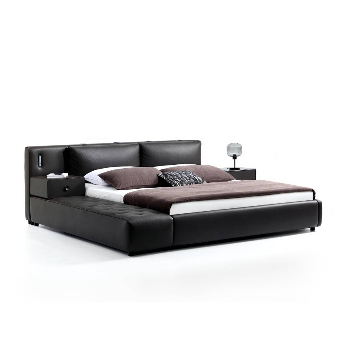 Side view of the black leather bed showing the headboard and chaise lounge