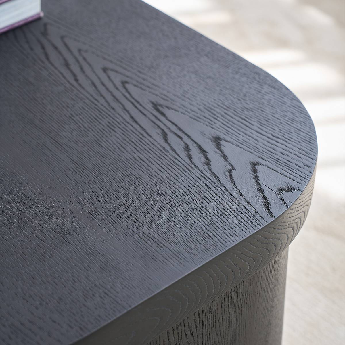 Close-up of the dark wood grain texture on the side table