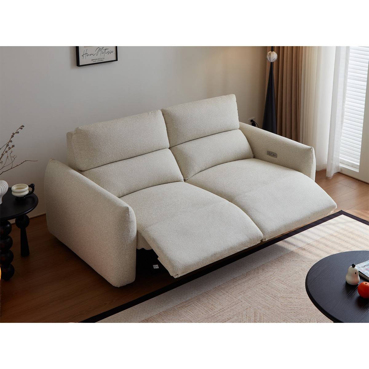 Close-up of the sofa armrest showing built-in USB charging ports and power outlet