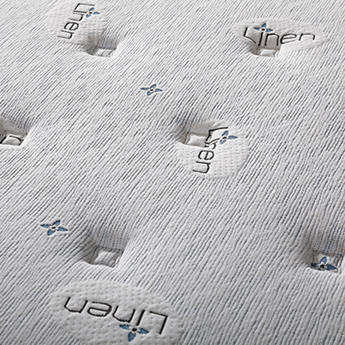 Close-up of the mattress surface showing the Linen embroidery pattern