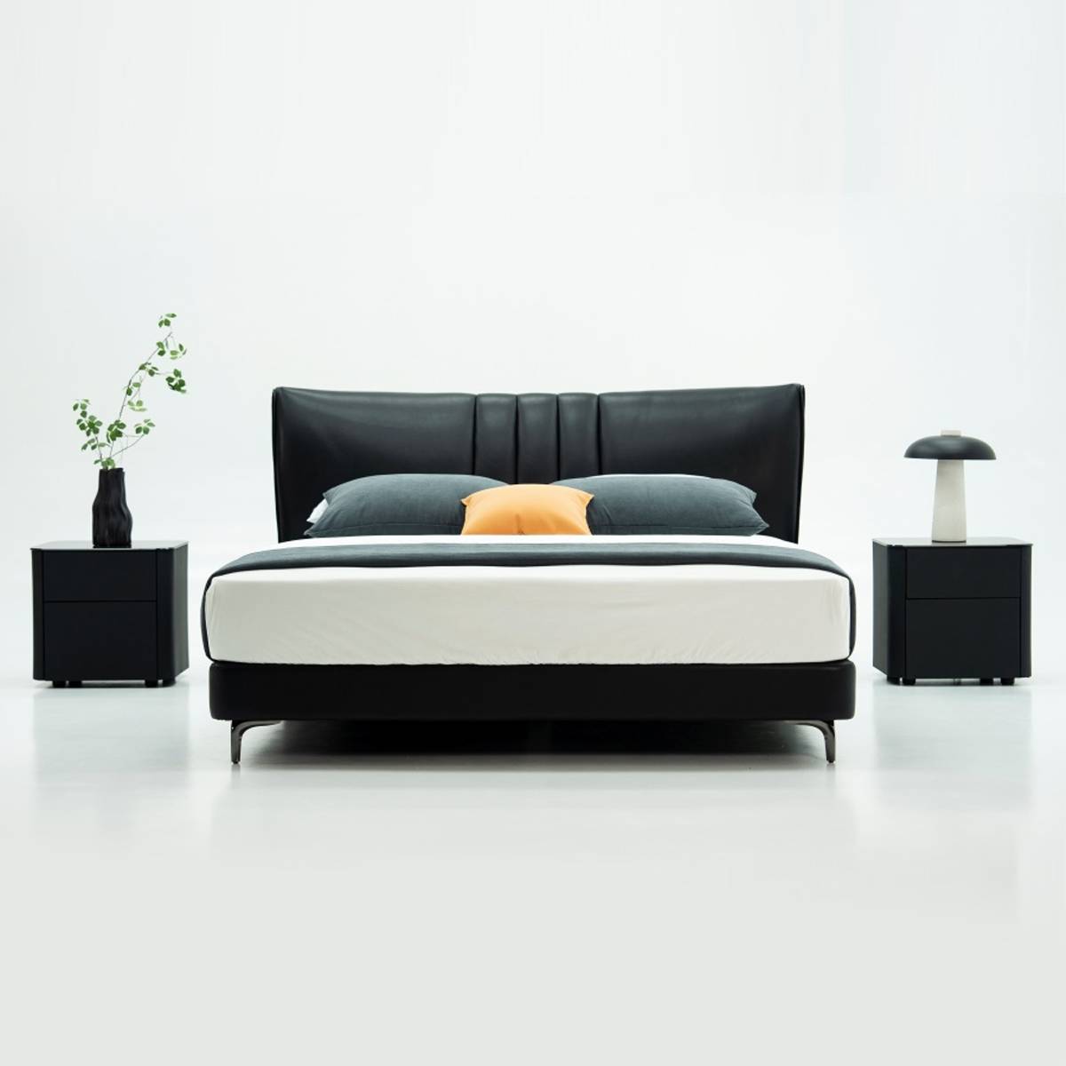 Front view of the black upholstered bed version with grey bedding