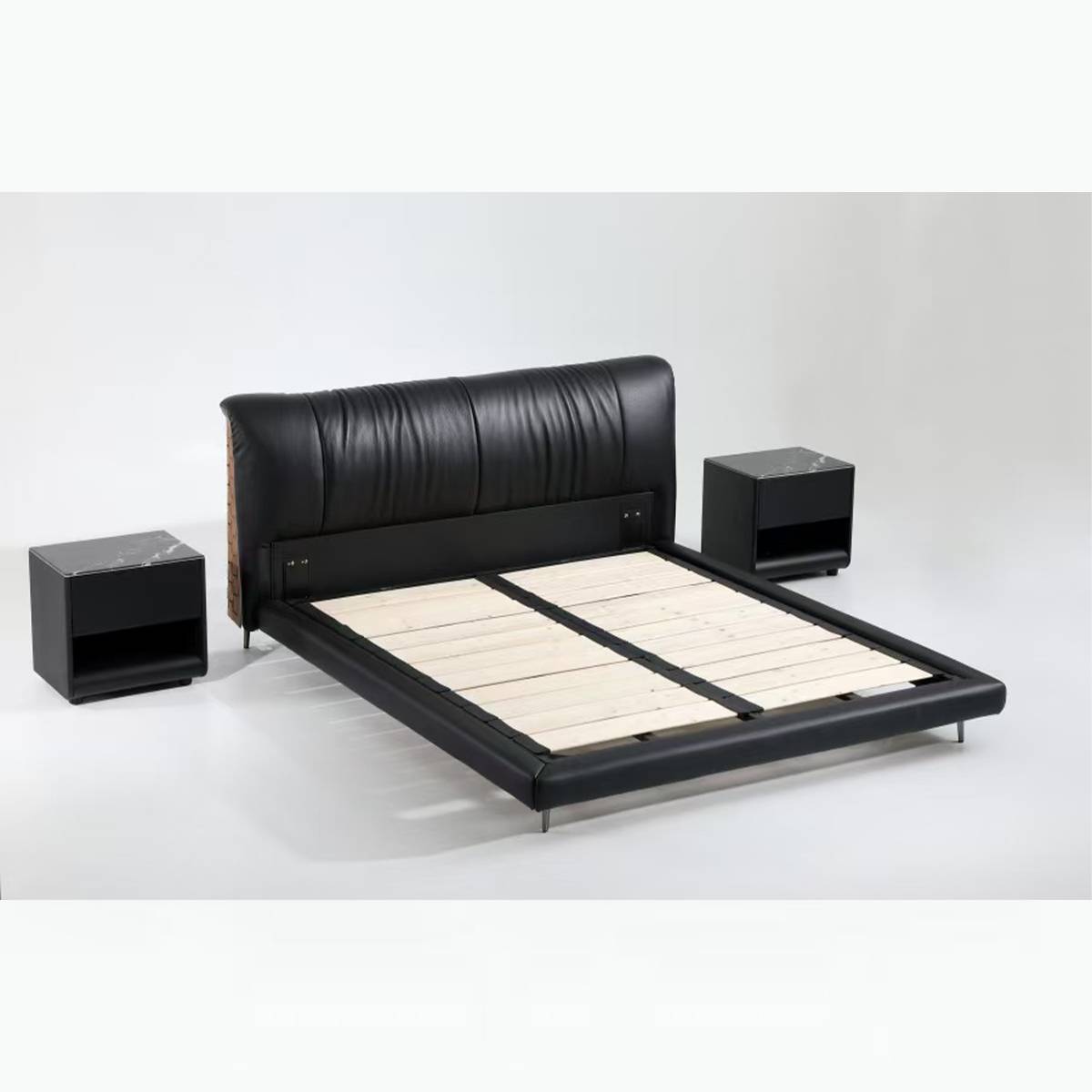 Close-up of the bed headboard corner showing the black leather and tan woven leather side panel