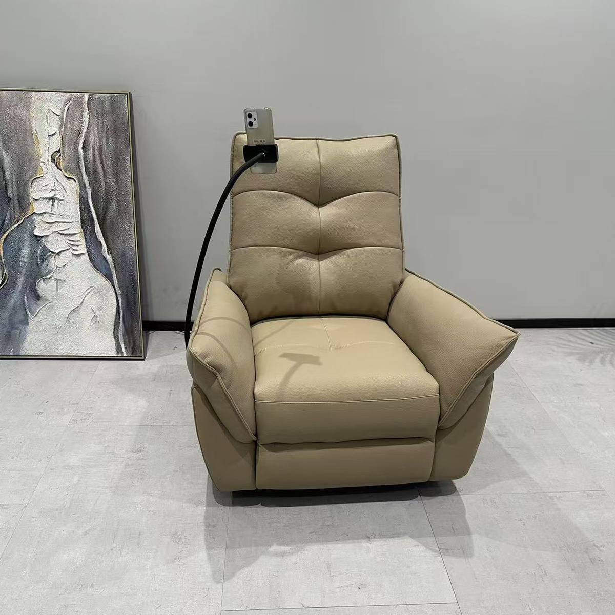 Front view of beige recliner chair with phone holder attachment