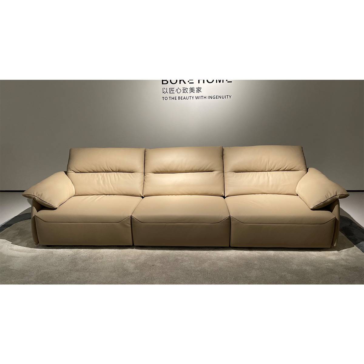 Front view of the beige leather sofa showing three seat cushions