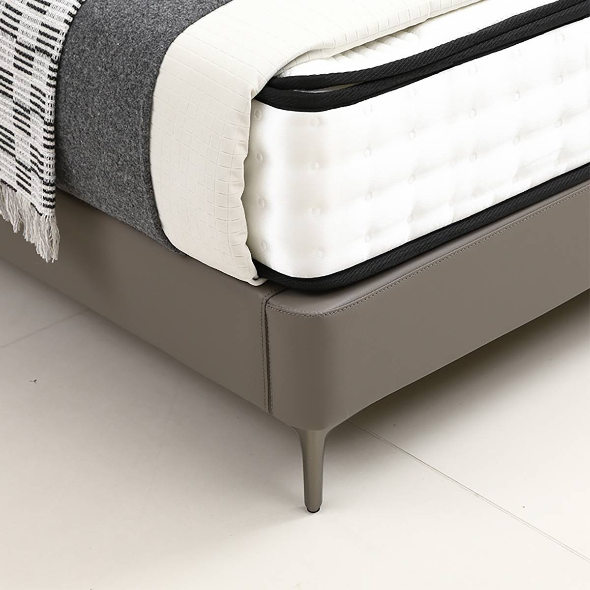 Close-up detail of the bed frame corner and tapered leg