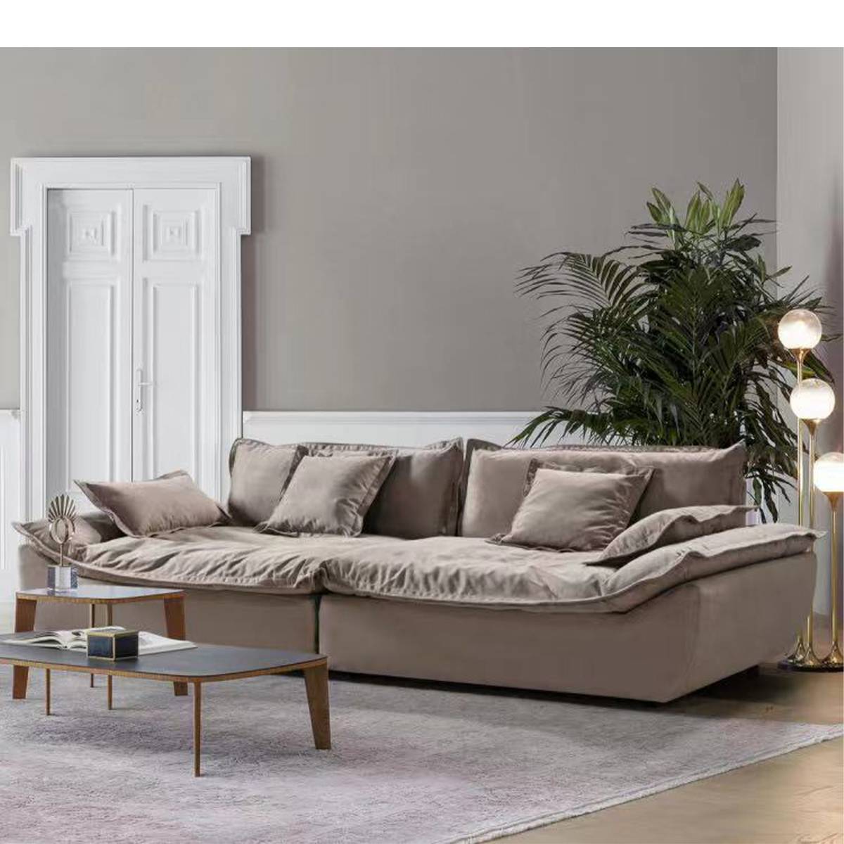 Beige fabric sailboat sofa with birch wood legs in a living room setting