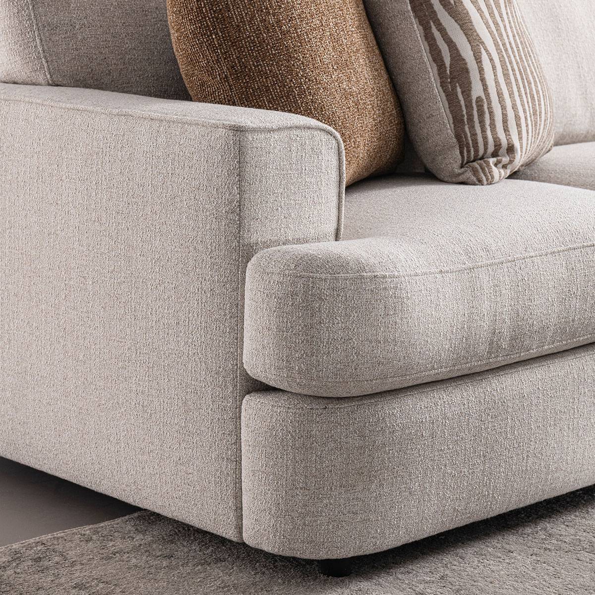 Close-up detail of the sofa seat cushion and armrest corner