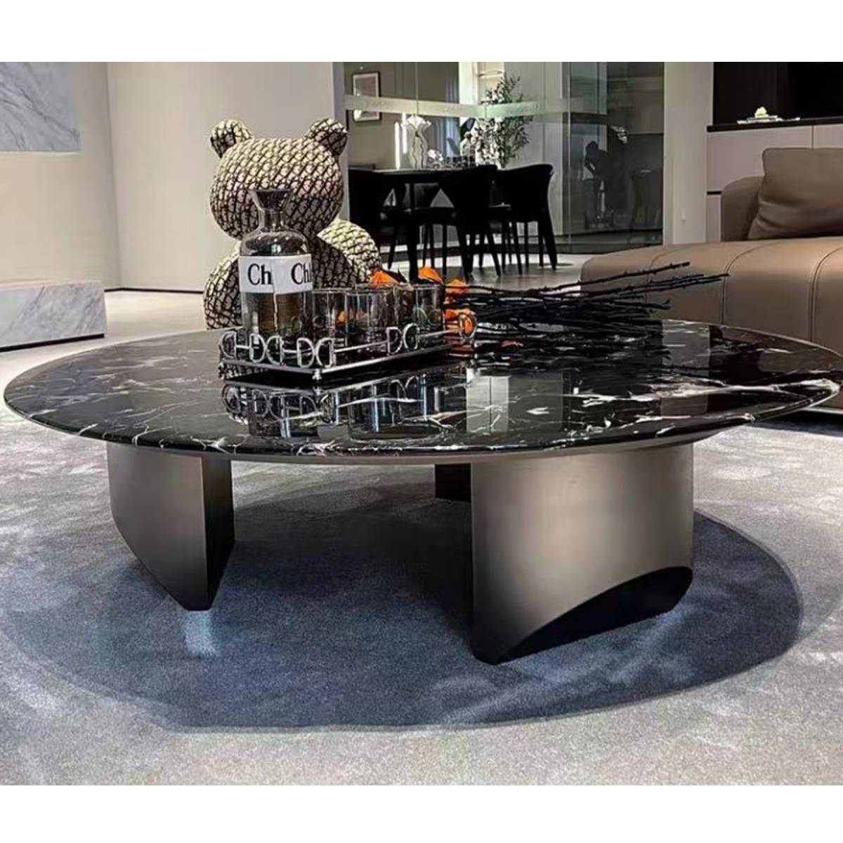 Side angle view of the coffee table showing the stainless steel base and marble top