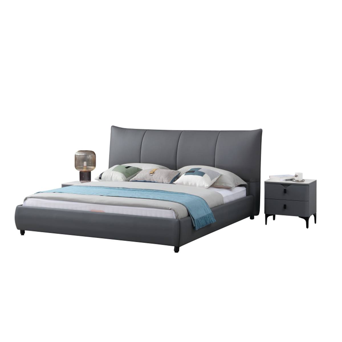 Full view of the grey upholstered bed with pillows and a blue throw blanket