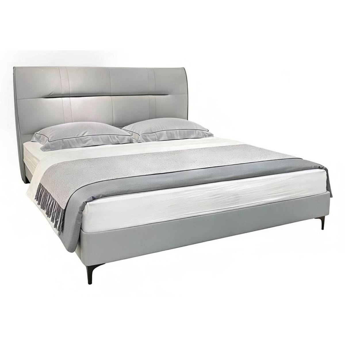 Front view of the light grey upholstered bed with grey bedding and throw