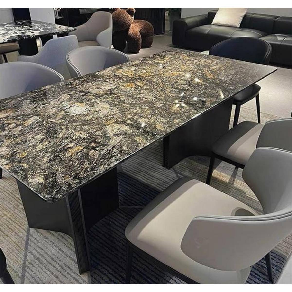 Close-up view of the Platinum Diamond marble dining table surrounded by dining chairs