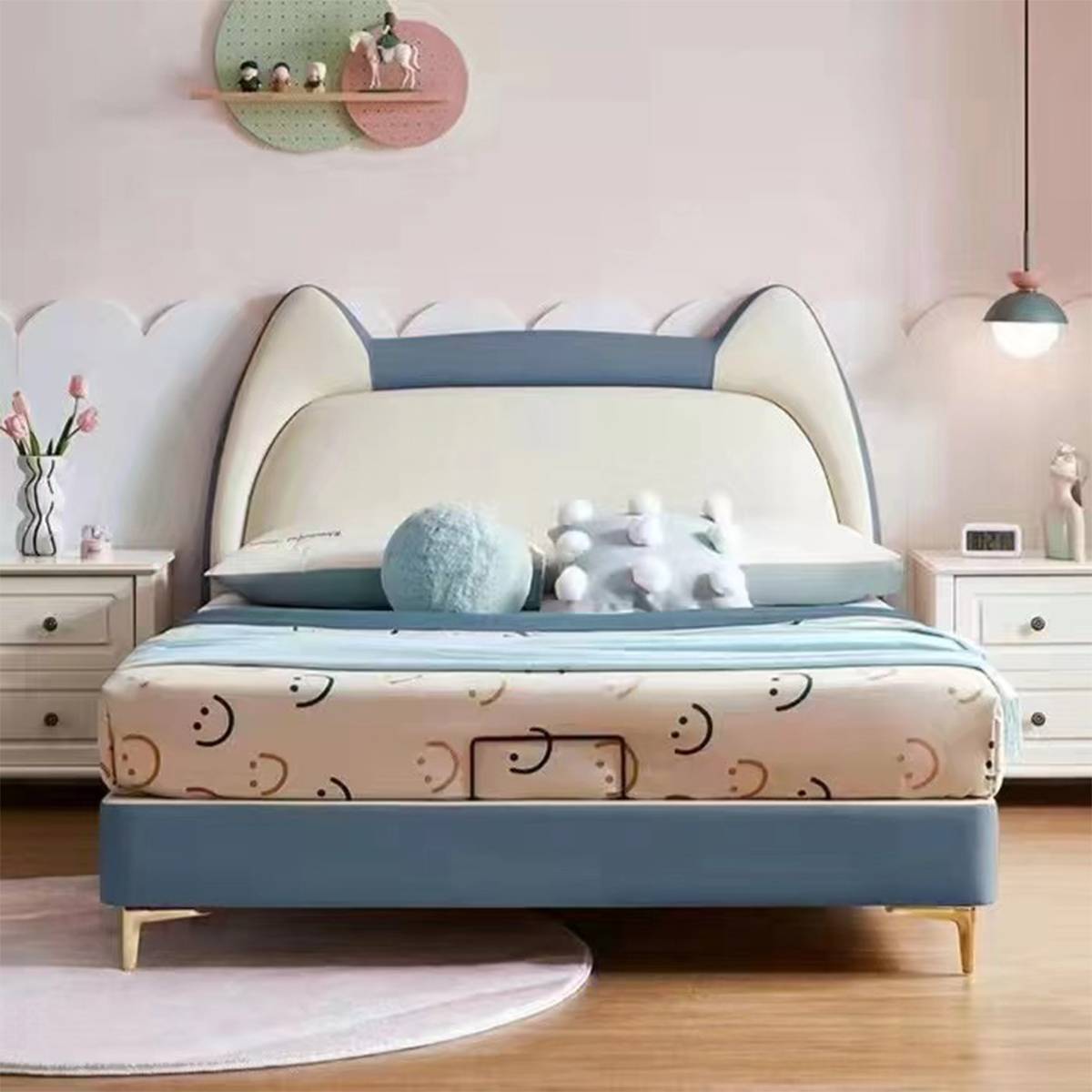 Blue and white cat-ear upholstered bed with patterned bedding